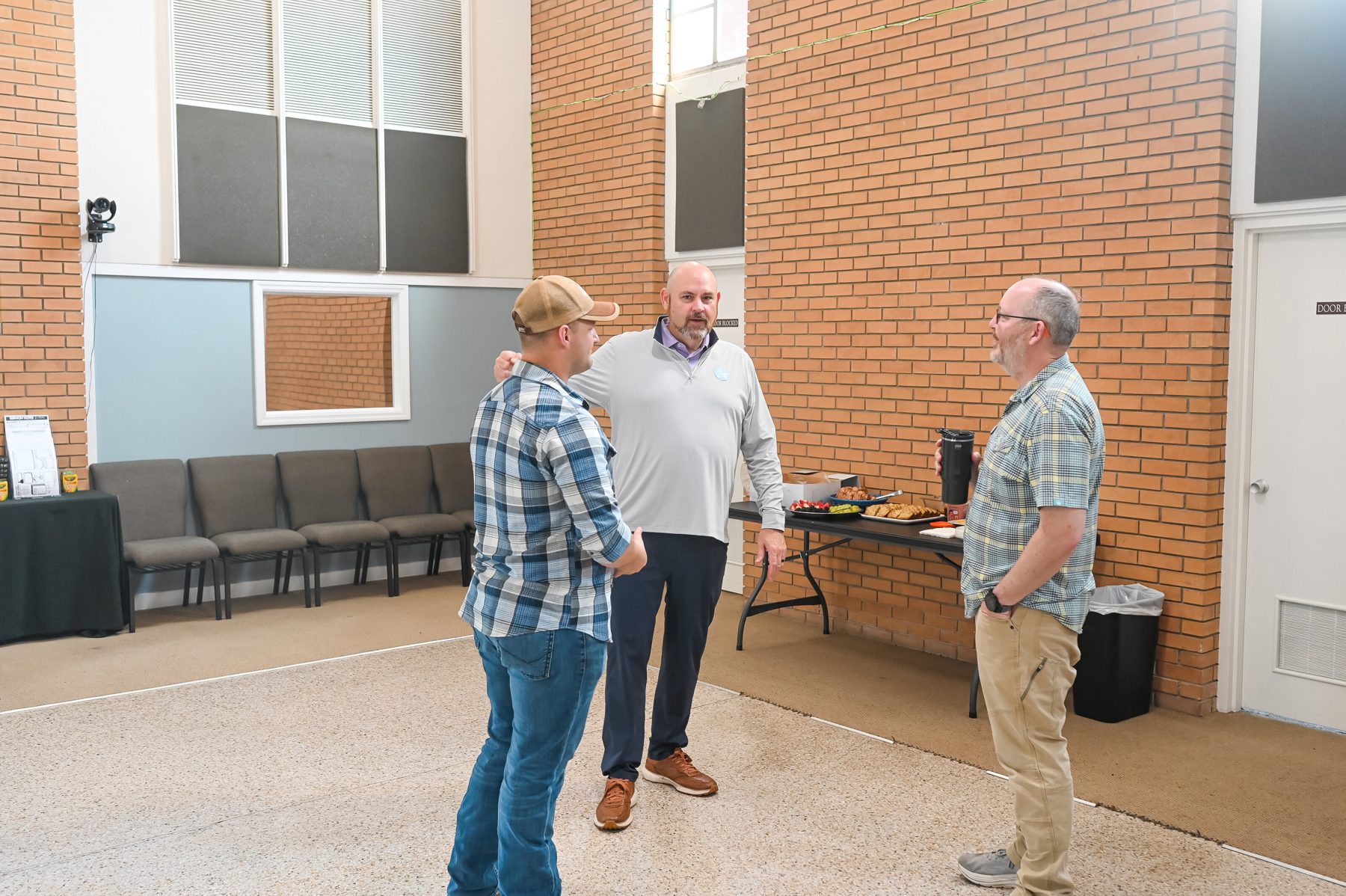 Men of Hope Bible Church in conversation outside the church